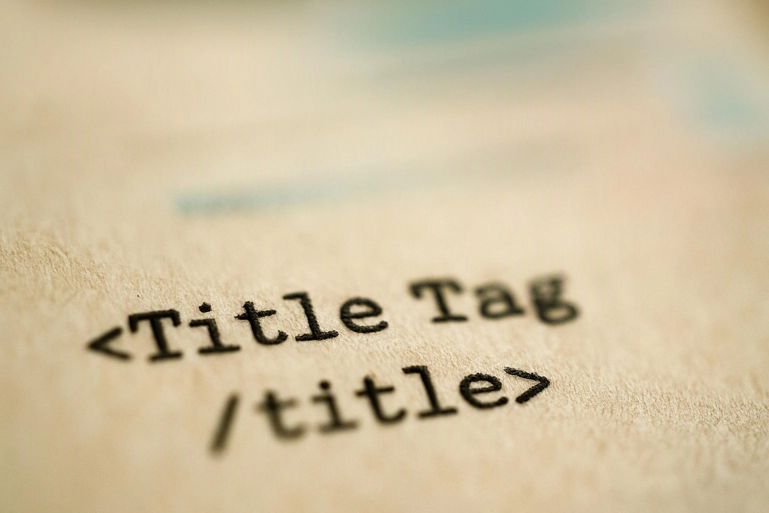Close-up of printed HTML title tag code on beige paper surface